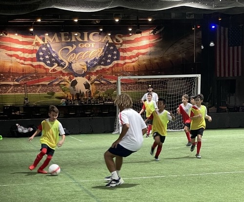 Image of kids soccer players vs. coaches